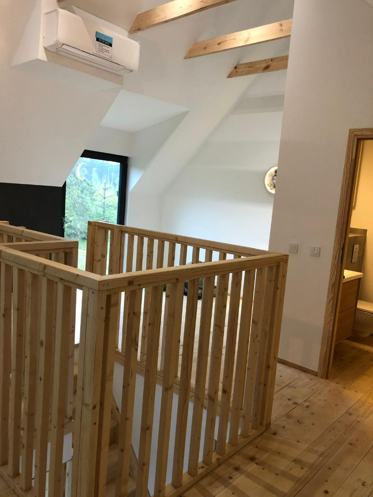 Poddasze z drewnianą balustradą wokół otworu na schody